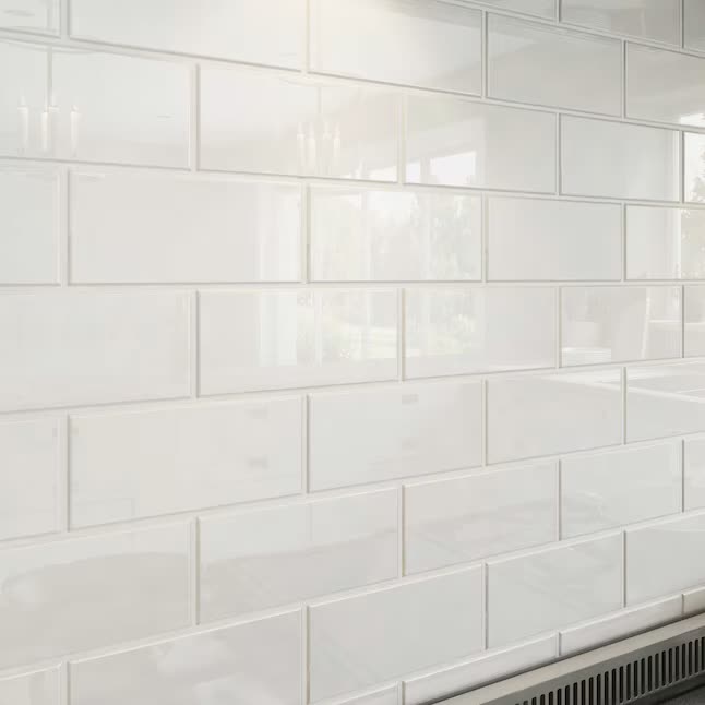 Matte white subway tile wall installed in a running bond pattern with even grout joints